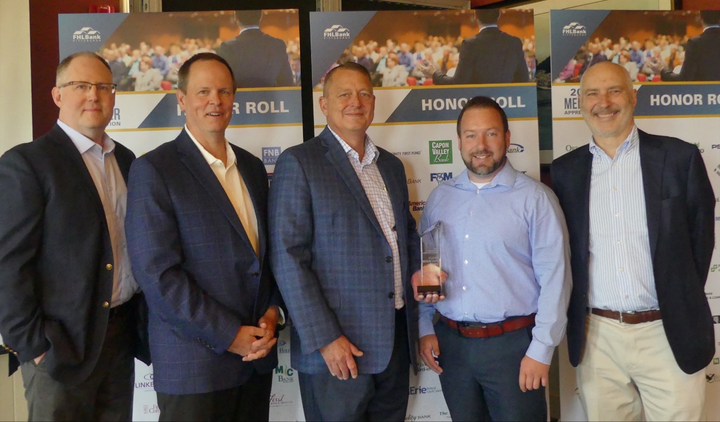 Accepting the Pillar of the Community Award are Clear Mountain Bank team members  Robert Flockvich (center), CRA officer and Director of Community Outreach and Retail Lending and Jesse Bumps, Commercial Lender. Also pictured from FHLBank (from left) are John Bendel, Senior Director of Community Investment; Dave Paulson COO; and Winthrop Watson, CEO (far right).