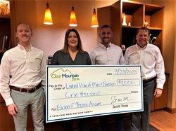 Pictured left to right are Chase Thomas, Harry Hayes and David Thomas of Clear Mountain Bank, presenting the $1,000 donation to Brandi Helms, CEO of United Way of Mon & Preston Counties.